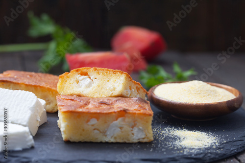 Homemade, freshly baked cornbread with cheese on dark background. Proja - bread  made of corn flour. Healthy food.