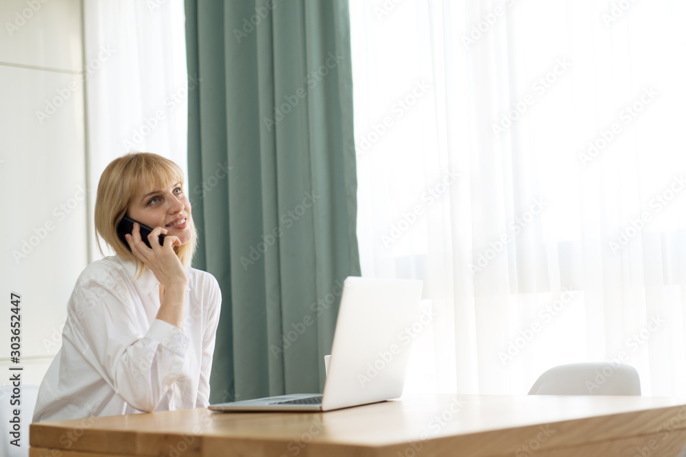 Beautiful pregnant business woman is talking on the mobile phone Beautiful pregnant business woman is talking on the mobile phone