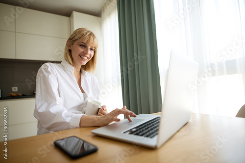 Beautiful pregnant business woman and smiling while sitting the working place at home