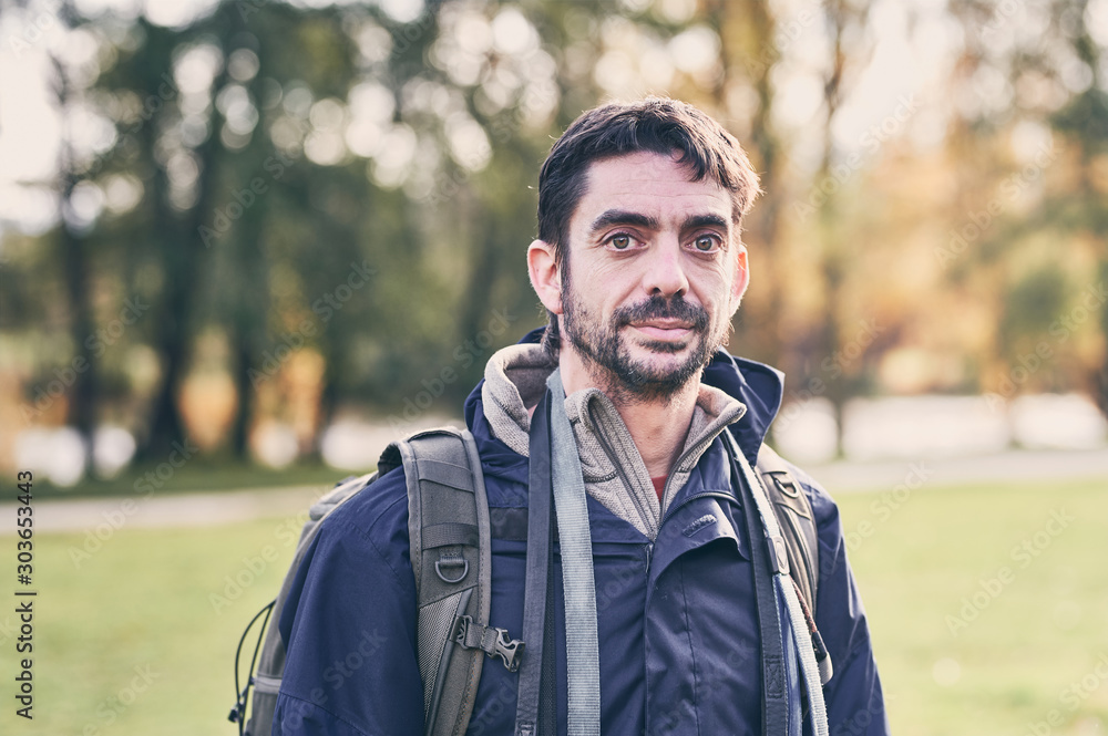 portrait of a young man with a rucksack and dogs leashes around his neck  Stock-Foto | Adobe Stock