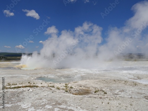 Wide cropped shot of steam rising from the Clepsydra Geyser at the Lower Geyser Basin, Yellowstone National Park.
