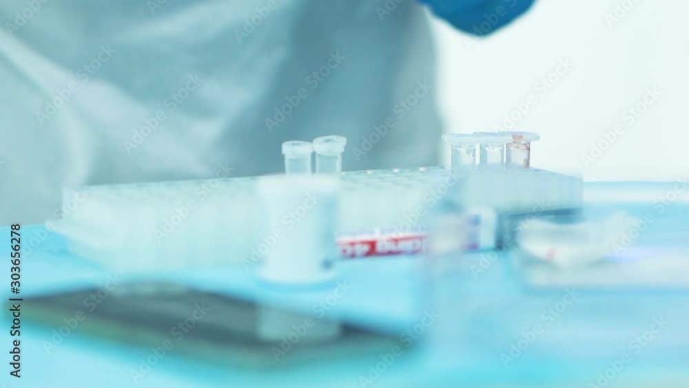 Medical scientist working in lab with probes test tubes glasses. genetic biohacking medicine research close-up Medical scientist working in lab with probes test tubes glasses. genetic biohacking medicine research close-up