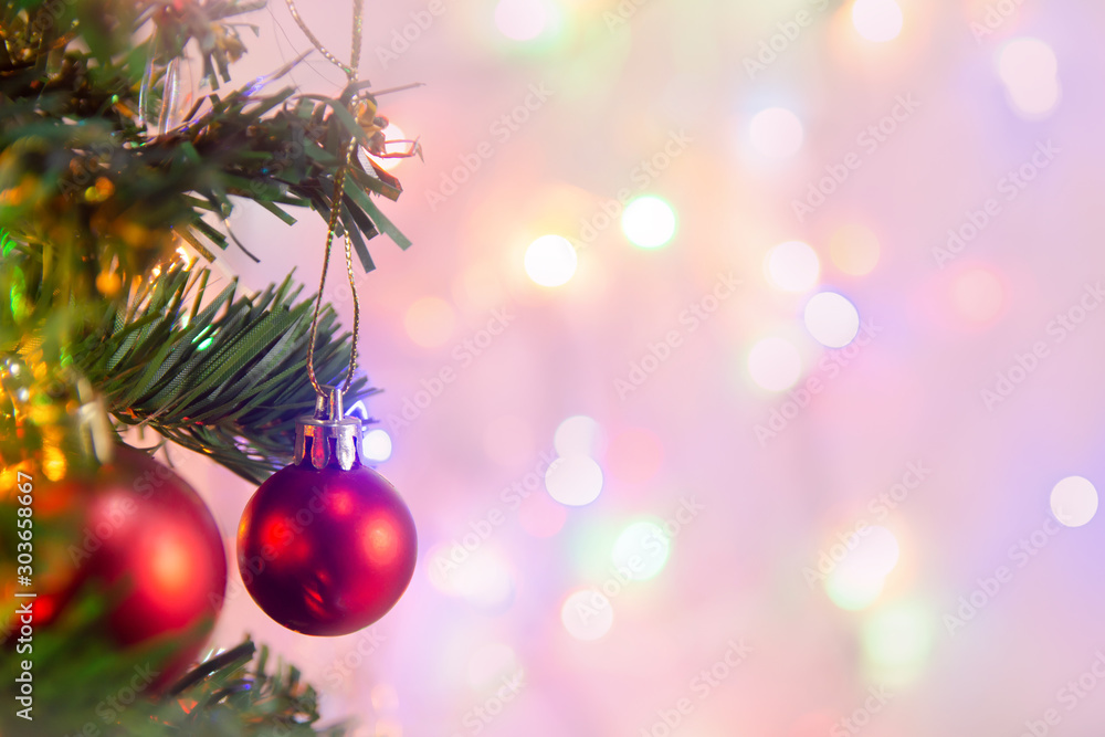 Christmas decoration. Hanging red balls on pine branches Christmas tree garland and ornaments over abstract bokeh background with copy space. Christmas decoration. Hanging red balls on pine branches Christmas tree garland and ornaments over abstract bokeh background with copy space.