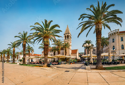 Sunny summer cityscape of Trogir. Empty moning street view of old Adriatic town. Beautiful world of Mediterranean countries. Traveling concept background.