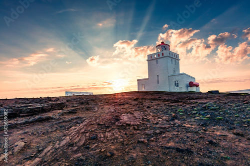 Fantastic evening view of Dyrholaey Lighthouse. Great summer sunset in Dyrholaey Nature Reserve, south coast of Iceland, Europe. Traveling concept background.