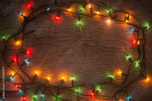 Christmas lights on wooden plank background. Merry Christmas and happy new year with copy space for a text...