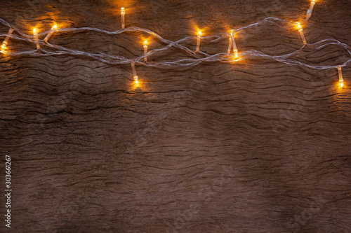 Christmas lights on wooden plank background. Merry Christmas and happy new year with copy space for a text...