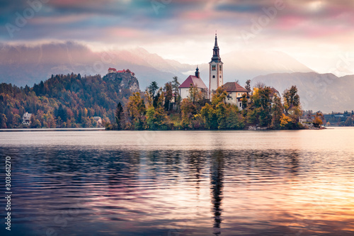 Dramatic morning view of Pilgrimage Church of the Assumption of Maria. Captivating autumn scene of Bled lake, Julian Alps, Slovenia, Europe. Traveling concept background.