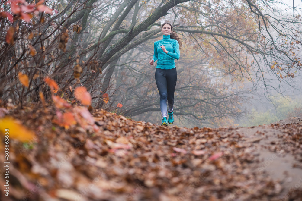 Female walking running in blue sportswear in park Female walking running in blue sportswear in park