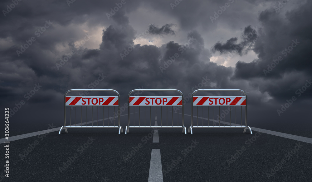 Φωτογραφία Asphalt road blocked by barriers with the words Stop and dark, gloomy clouds i