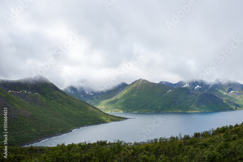 Beautiful nature landscape in North. Amazing scenic outdoors view. Ocean with waves, mountains. Fjord. Dramatic clouds. Tourist landmark. Travel, adventure, lifestyle. Explore Norway, Lofoten Islands