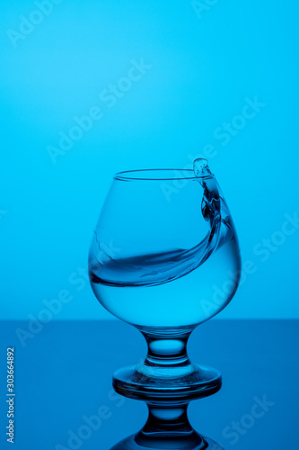 splash of water in a blue glass