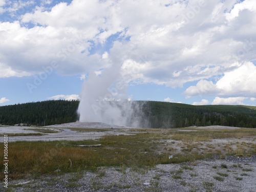 Old Faithful geyser during one of its regular eruptions at Yellowstone National Park, Wyoming.