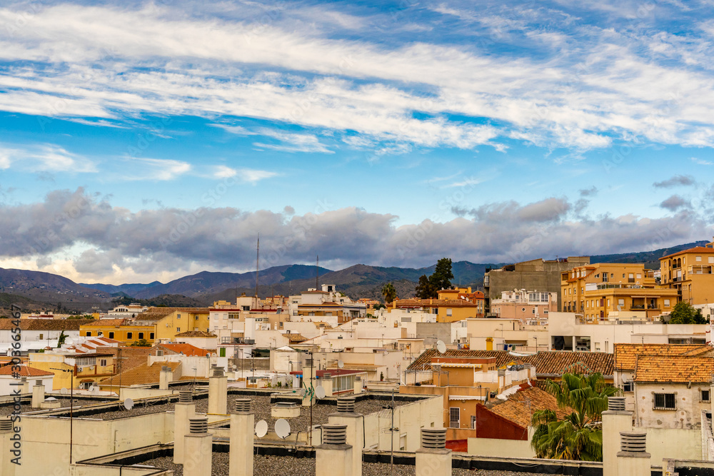 Blue sky with clouds over the city buildings in Malaga, Spain