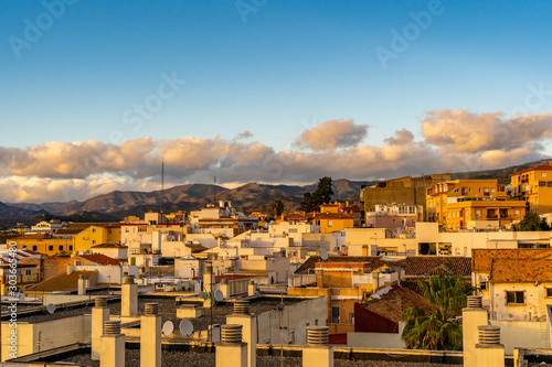 Blue sky with clouds over the city buildings in Malaga, Spain