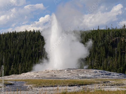 Colums of scalding water and steam spurts out of the Old Faithful geyser during an early morning eruption at Yellowstone National Park, Wyoming.