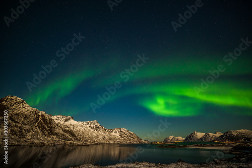 Aurora borealis, Northern Lights with mountains in background over Senja, Norway