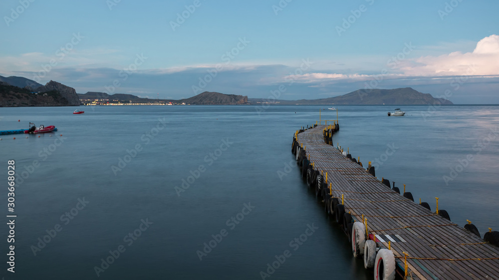 mooring in the bay, floating pier, a long pier