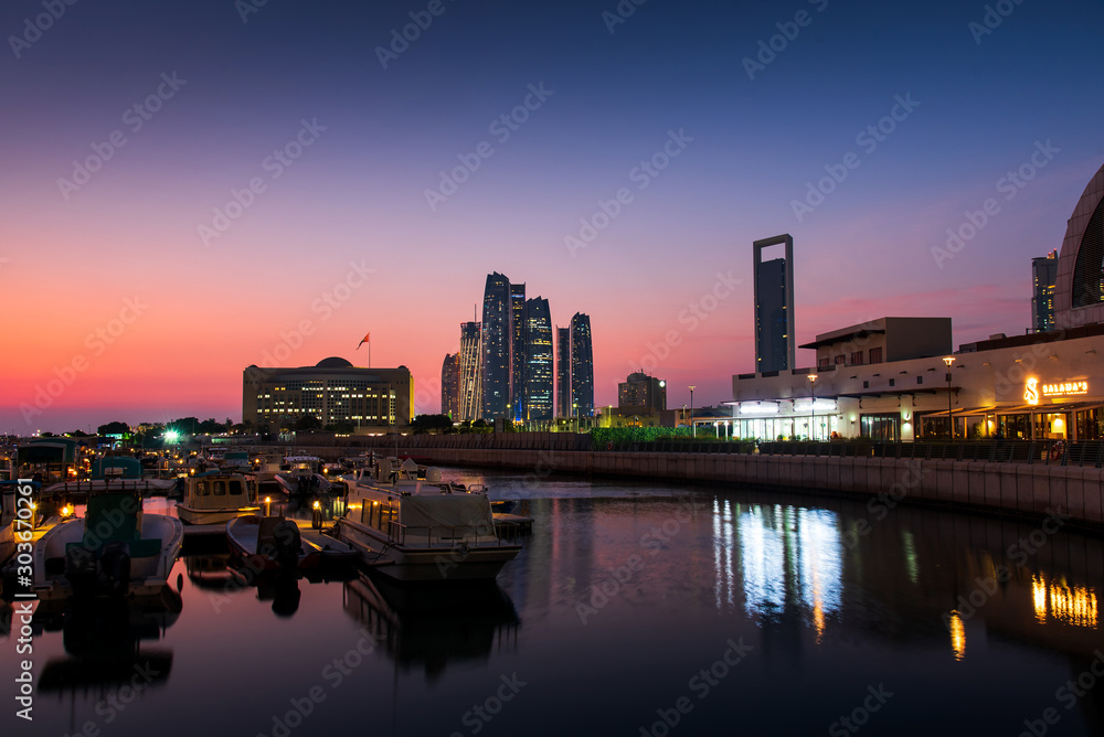 Abu Dhabi modern skyline reflected in the water of Al Bateen marina