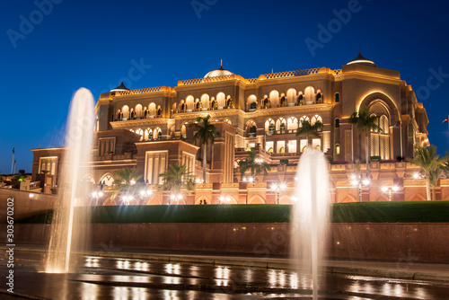 Emirates palace in Abu dhabi reflected on the ground level fountain photo