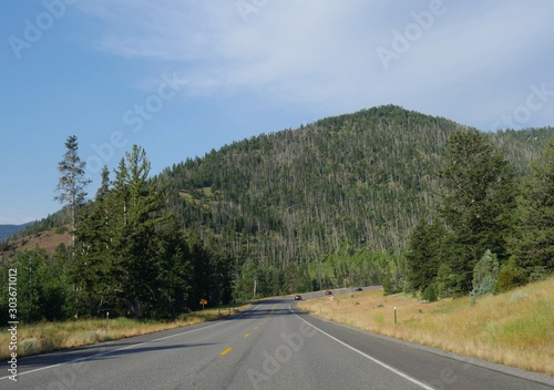 Cody, Wyoming, USA--July 2018: Sloping paved road at North Fork Highway to Yellowstone National Park east entrance.