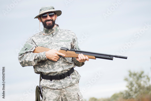 smiling hunter holding rifle
