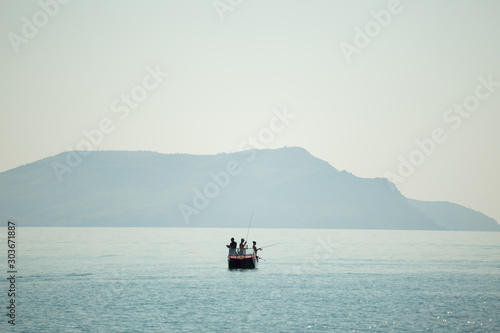 small boat on the background of the mountain in the sea