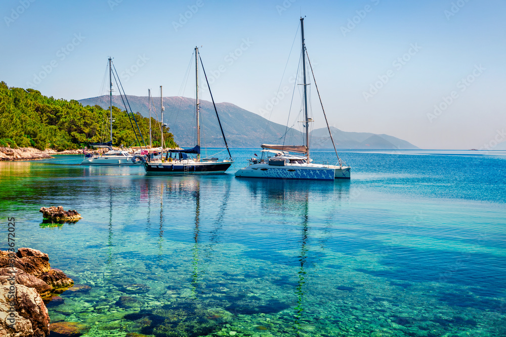 Fototapeta premium Attractive morning view of Fiskardo port. Amazing summer seascape of Ionian Sea. Colorful scene of Kefalonia island, Greece, Europe. Traveling concept background.