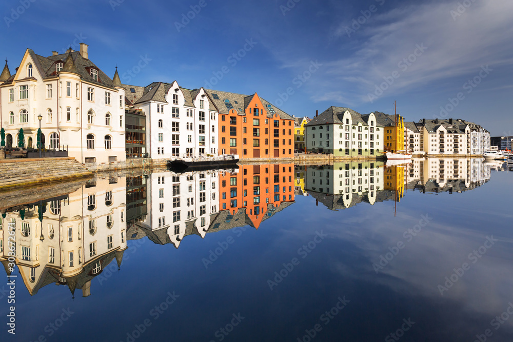 Colorful architecture of Alesund reflected in the water, Norway