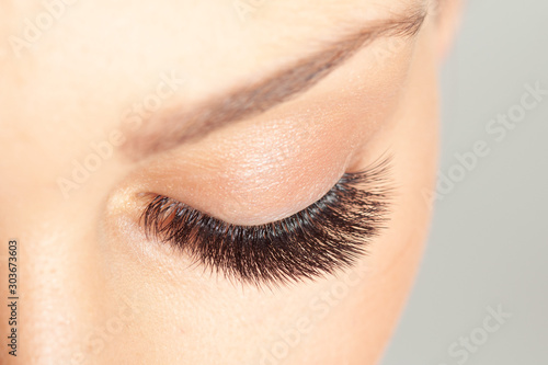 Close up shot of closed eye with long eyelashes. Eyelash Extension. Beautiful Lashes macro.