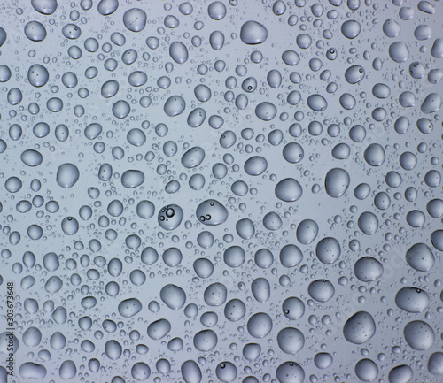 Drops of water on clear glass. Window background with dew.