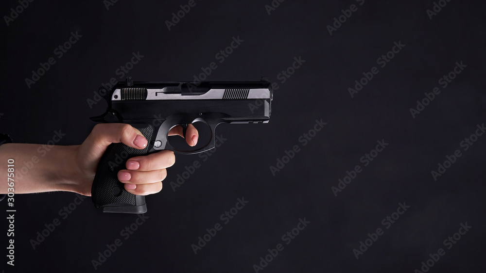 female hand with a gun. female hand with a gun.