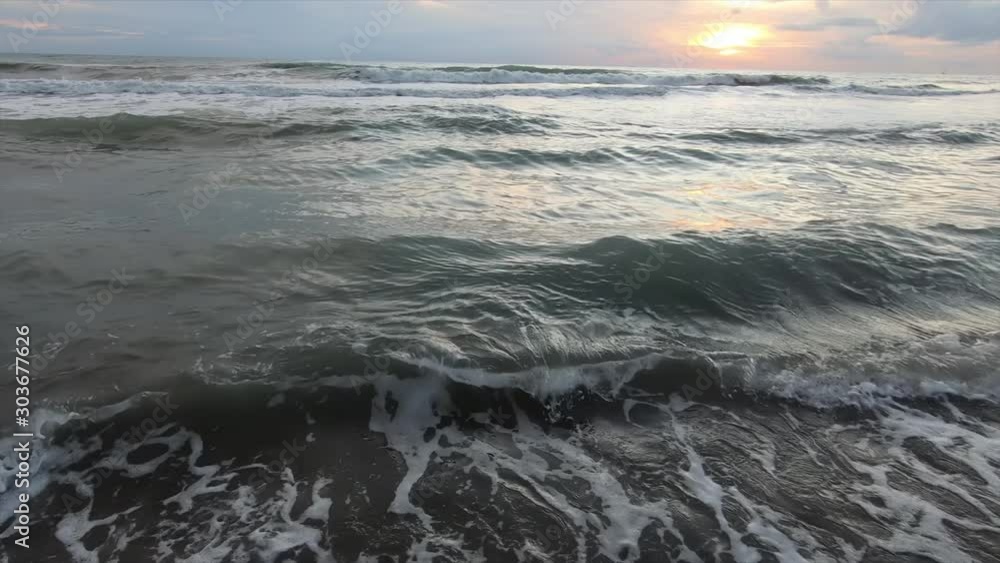 The huge beach of Patara in Turkey on the Mediterranean coast in the evening at sunset. Natural background. Panorama of a sea landscape with waves and cloudy sky The huge beach of Patara in Turkey on the Mediterranean coast in the evening at sunset. Natural background. Panorama of a sea landscape with waves and cloudy sky