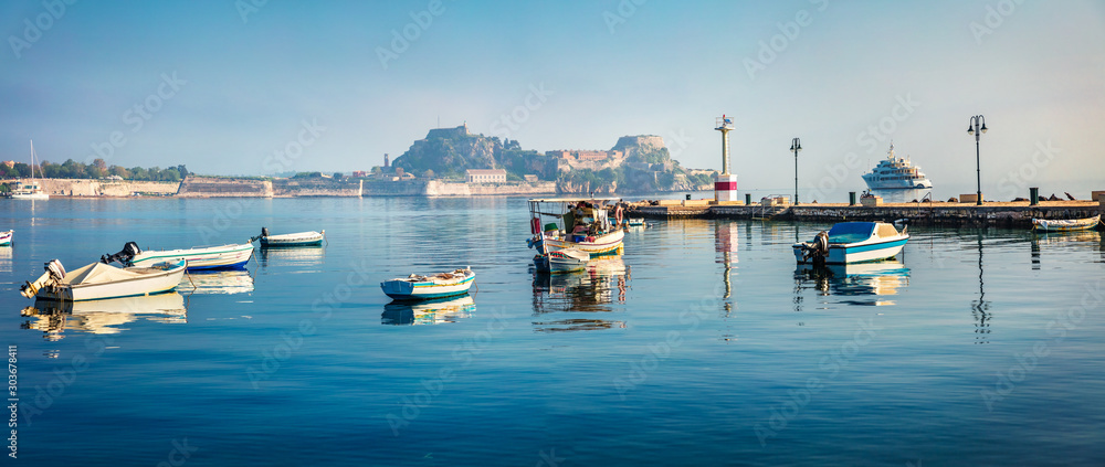 Panoramic morning view of the old Venetian fortress in Kerkira, capital of Corfu island. Sunny summer seascape of Ionian Sea, Greece, Europe. Traveling concept background.