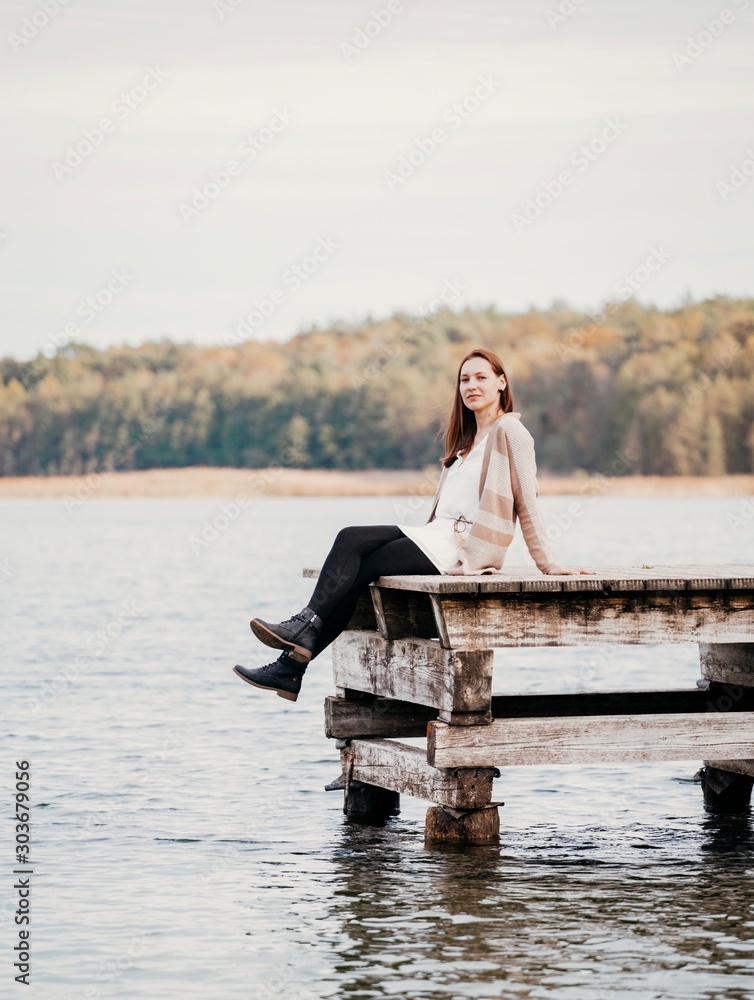 woman sitting on pier