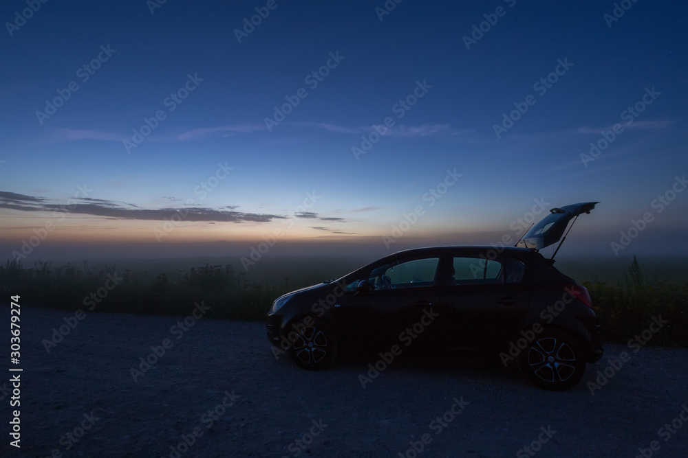 car in the night in the field, backlight