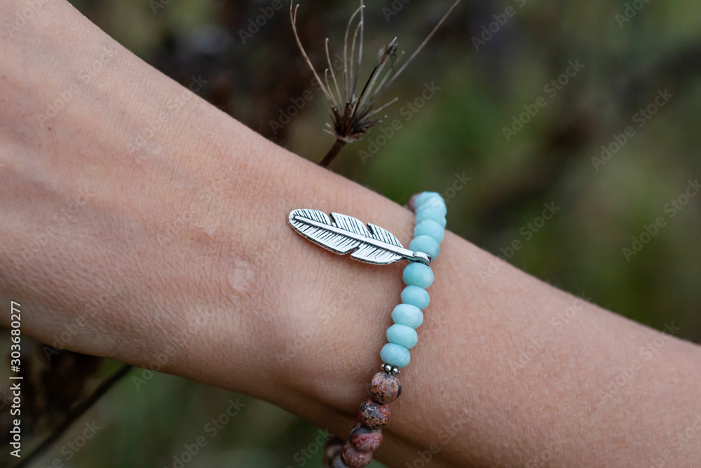 faceted mineral stone beads metal pendant bracelet on female wrist faceted mineral stone beads metal pendant bracelet on female wrist