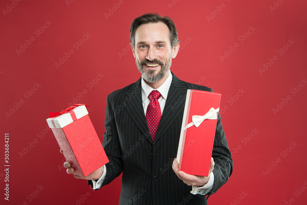 Romantic gift. Mature businessman hold gift box red background. Surprise concept. Christmas gift. Happy holidays. From sincere heart. Man happy smiling face celebrate new year. Valentines day gift Romantic gift. Mature businessman hold gift box red background. Surprise concept. Christmas gift. Happy holidays. From sincere heart. Man happy smiling face celebrate new year. Valentines day gift