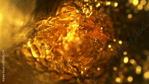 Super slow motion of pouring whiskey, rum or ice tea, inside bottle view. Filmed on high speed cinema camera, 1000 fps. photo