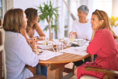 Young beautiful girl smiling happy and confident sitting dinking cup of coffee at terrace