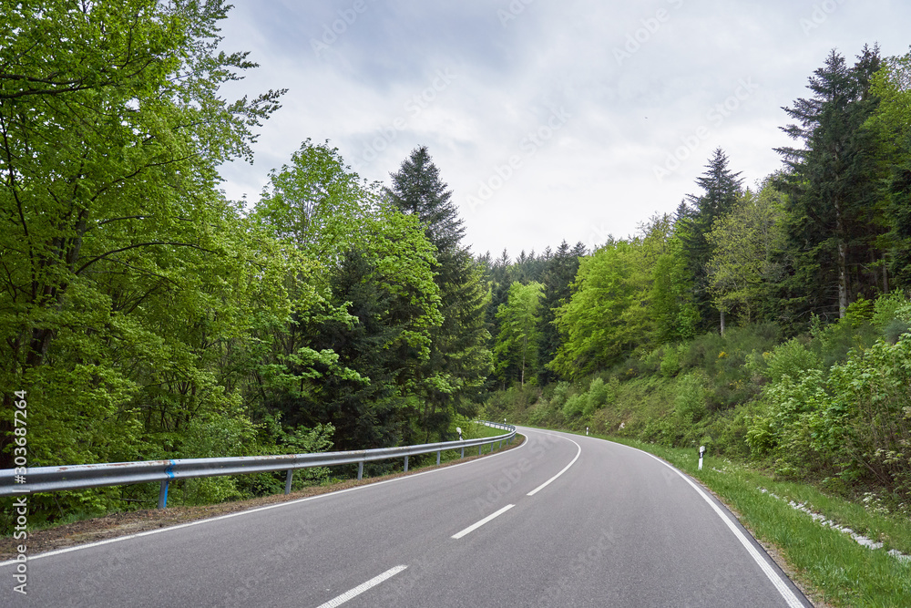 Beautiful asphalt road with turns through the Schwarzwald forest in Germany