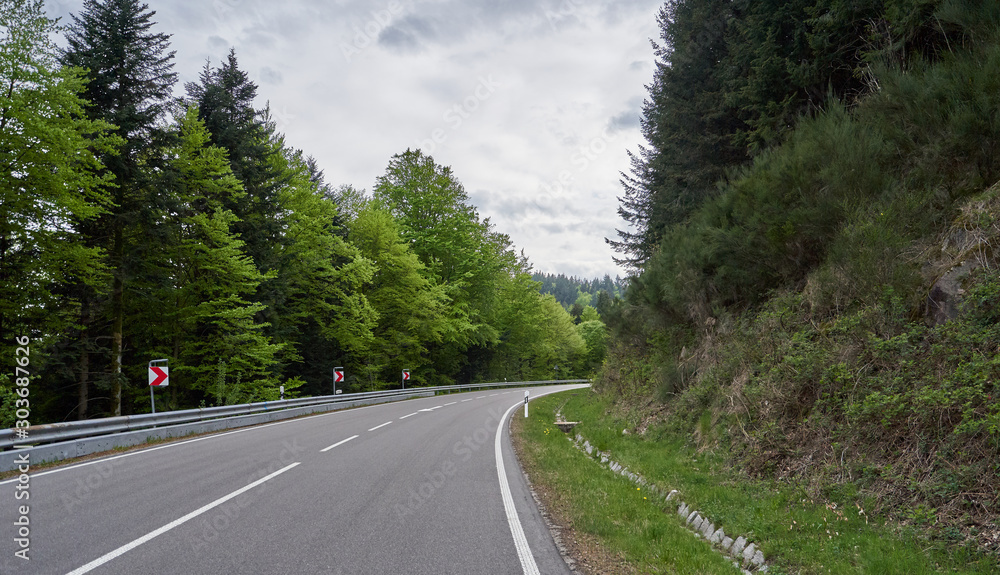 Beautiful asphalt road with turns through the Schwarzwald forest in Germany Beautiful asphalt road with turns through the Schwarzwald forest in Germany
