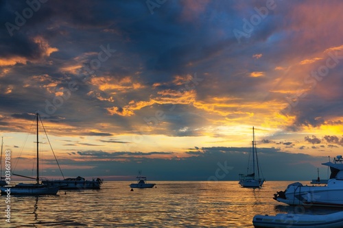 Sunset at boat marina with dramatic sky photo