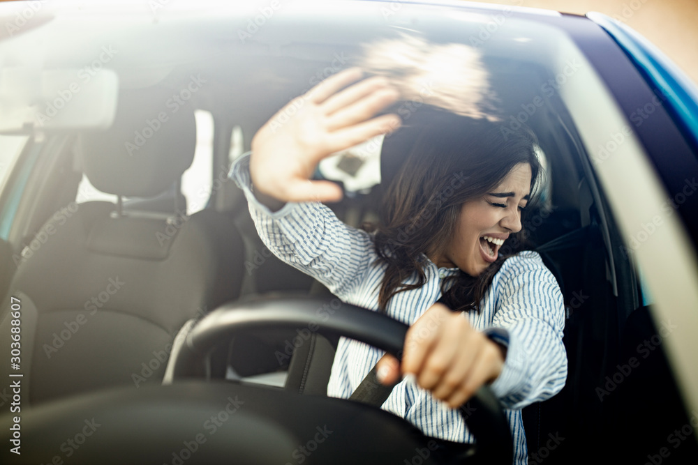 Obraz na plátně Young terrified woman driving and having a car accident