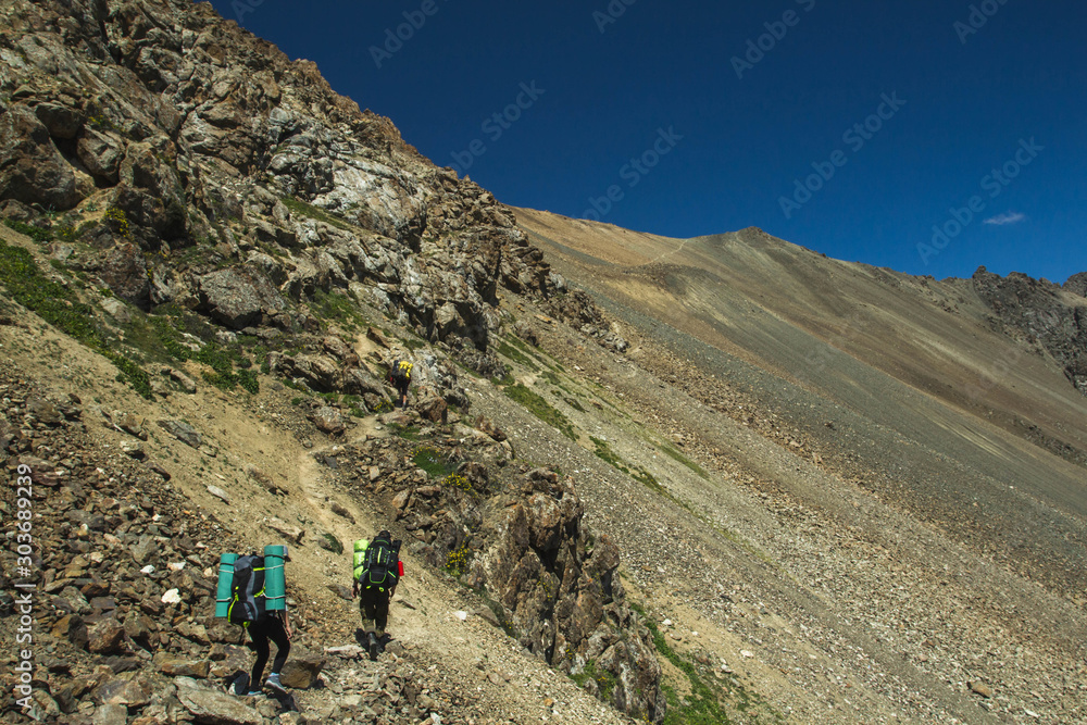 trekking in the mountains, people with backpacks, tian shan, Kyrgyzstan