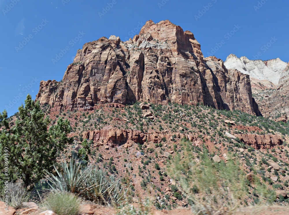 Naklejka premium Cropped view of high steep sharp cliffs and gorgeous clouds at Zion National Park, Utah, USA.