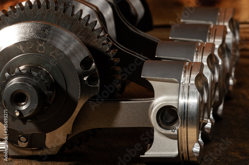 high performance motorcycle engine parts on a workbench. pistons connecting rods clutch and tools  photo