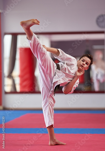 Young karate student executing a kata photo