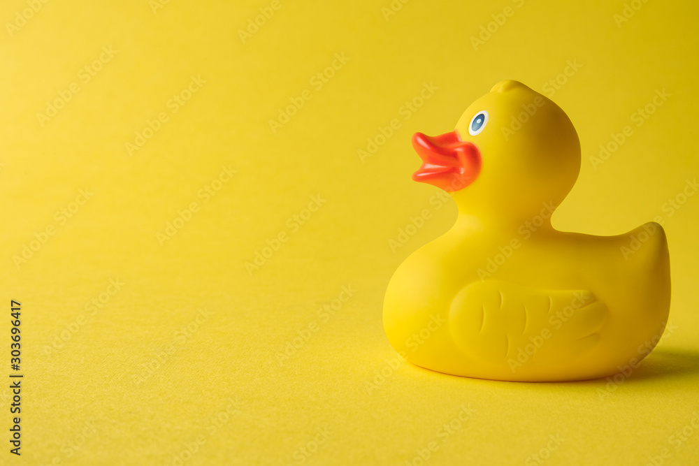 Rubber duck on yellow background minimal creative concept. Space for copy. Rubber duck on yellow background minimal creative concept. Space for copy.