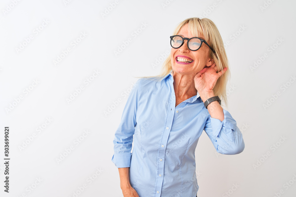 Middle age businesswoman wearing elegant shirt and glasses over isolated white background smiling with hand over ear listening an hearing to rumor or gossip. Deafness concept. Middle age businesswoman wearing elegant shirt and glasses over isolated white background smiling with hand over ear listening an hearing to rumor or gossip. Deafness concept.